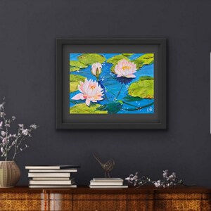 May include: A framed painting of pink water lilies on a blue background with green lily pads. The painting is signed "I.G."