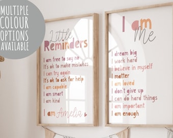 May include: Two framed prints with inspirational messages for children. The print on the left says "Little Reminders" and includes phrases like "I am free to say no" and "I am Amelia". The print on the right says "I am Me" and includes phrases like "I dream big" and "I am enough".