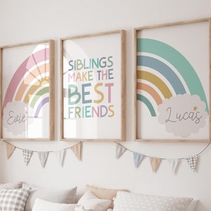 May include: Two framed rainbow prints with the text "Siblings make the best friends" in the centre print and the names "Evie" and "Lucas" in the other two prints.