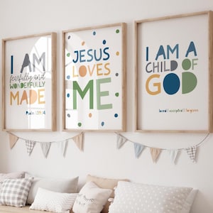 May include: Three framed art prints with inspirational quotes. The prints feature colourful text on a white background, including "I AM fearfully and wonderfully made," "JESUS LOVES ME," and "I AM A CHILD OF GOD." The frames are light brown.
