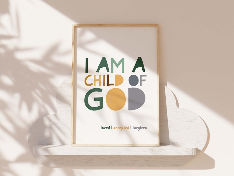May include: A framed print with the text "I am a child of God" in green, yellow, and gray letters. The text "loved | accepted | forgiven" is printed below in smaller letters.