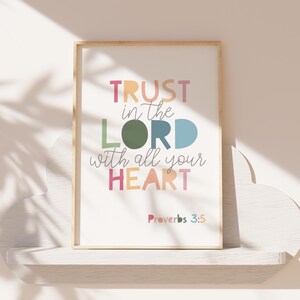 May include: A framed print with a white background and colorful text that reads "TRUST in the LORD with all your HEART" and "Proverbs 3:5".