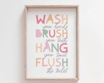 May include: A framed print with the text "WASH your hands BRUSH your teeth HANG your towel FLUSH the toilet" in colorful, layered letters.