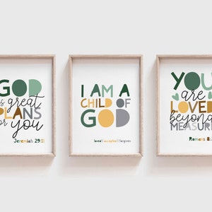 May include: Three framed prints with inspirational quotes and bible verses. The first print is green and gold and says "God has great plans for you - Jeremiah 29:11". The second print is green, gold, and gray and says "I am a child of God - loved, accepted, forgiven". The third print is green, gold, and gray and says "You are loved beyond measure - Romans 8:38".