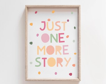 May include: A framed print with a white background and colourful text that reads "Just One More Story". The text is surrounded by small colourful dots.