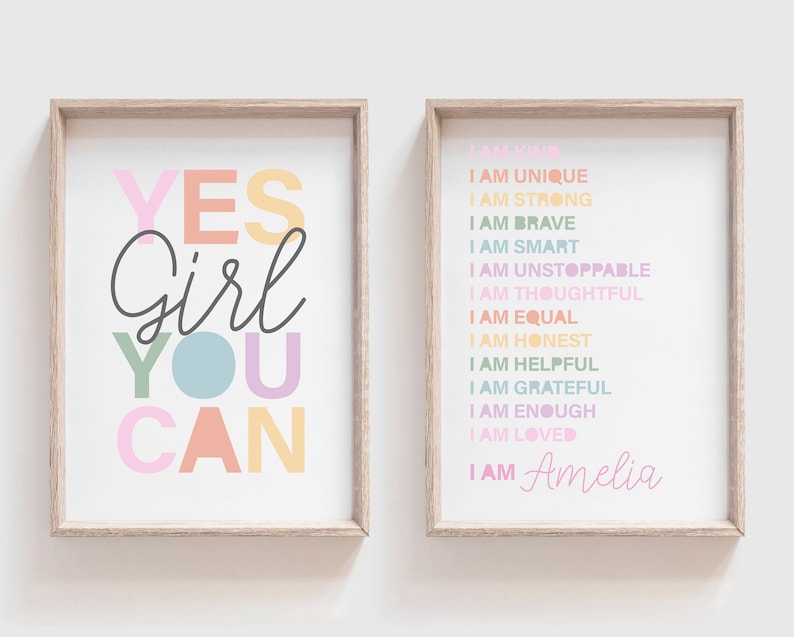 May include: Two framed prints with inspirational quotes. One says "YES Girl YOU CAN" in colorful letters. The other lists positive affirmations like "I AM STRONG" and "I AM BRAVE", with the name "Amelia" at the bottom.
