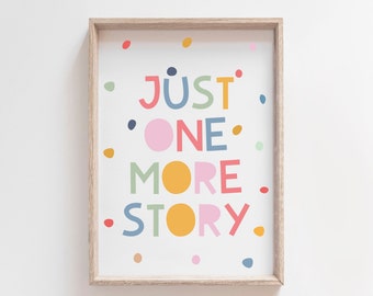 May include: A framed print with a white background and colourful text that reads "JUST ONE MORE STORY". The text is surrounded by small colourful dots.