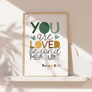 May include: A framed print with a white background and green, yellow, and gray text that reads "You are loved beyond measure Romans 8:38".