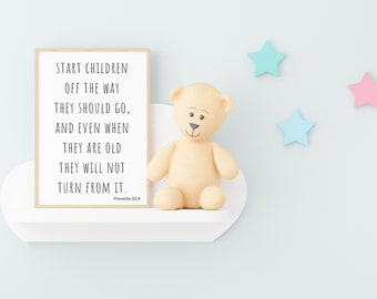 May include: A framed print with a white background and black text that reads "Start children off the way they should go, and even when they are old they will not turn from it. Proverbs 22:6". A beige teddy bear sits on a white shelf in front of the print. Three pastel stars are on the wall behind the shelf.