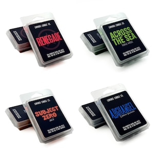 May include: Eight wax melt packages with various text labels, including "Paragon," "Renegade," and "Across the Sea." Each package has a black label with white text and a clear plastic casing. The products are from Lumina Candle Co.