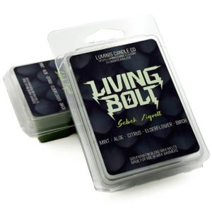 May include: Two packages of Living Bolt wax melts. The front package has a black label with white text that reads "Living Bolt" and "Sebek Zigvolt." The scent is "Mint - Aloe - Citrus - Elderflower - Birch." The wax melts are green.