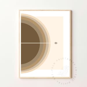 Puede incluir: Impresión geométrica abstracta con un diseño de medio círculo en tonos marrones, beige y crema. La impresión presenta una fina línea blanca en el centro y un pequeño círculo gris en la esquina superior derecha.