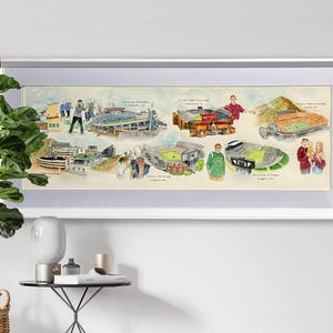 May include: A framed watercolor print featuring illustrations of various college football stadiums. The artwork includes depictions of stadiums from the University of Alabama, Florida State University, and the University of Oregon, among others. The print is encased in a silver frame.