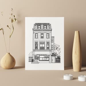 May include: Black and white line drawing of a three-storey building with a shop front. The building has a pitched roof, windows, and a door. The shop front has a sign that reads "The Daily Grind".