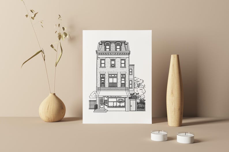 May include: Black and white line drawing of a three-storey building with a shop front. The building has a pitched roof, windows, and a door. The shop front has a sign that reads "The Daily Grind".