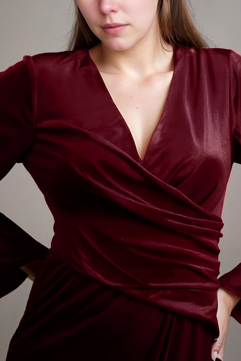 a woman in a red dress posing for a picture