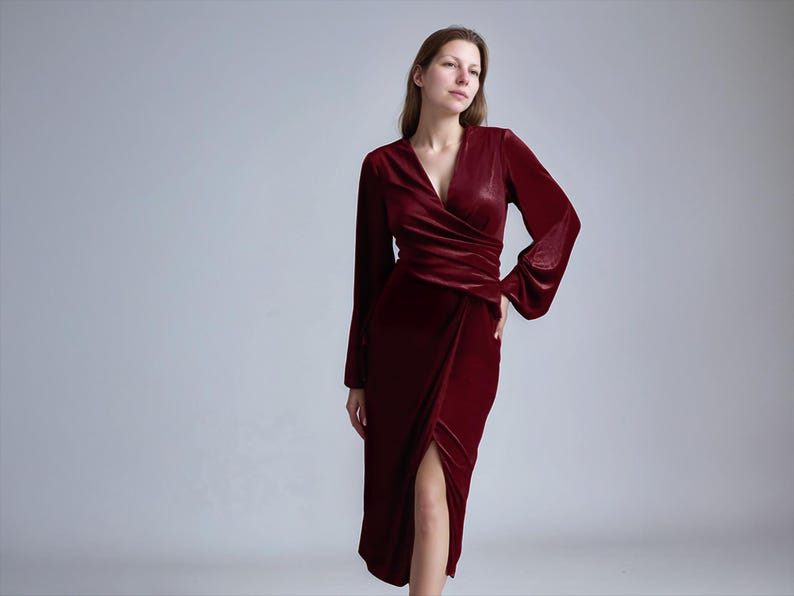a woman in a red dress posing for a picture