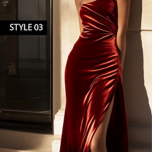 May include: A long, red velvet dress with a single slit on the left side. The dress has a strapless neckline and a fitted bodice. The dress is styled with a simple, elegant look.