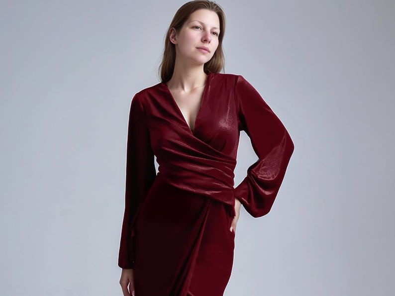 a woman in a red dress posing for a picture