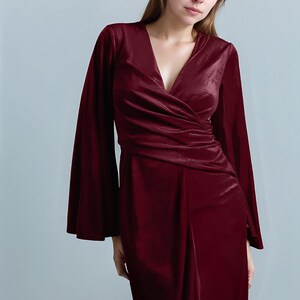 a woman in a red dress posing for a picture