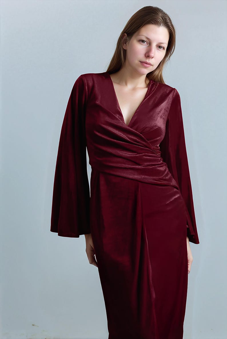 a woman in a red dress posing for a picture