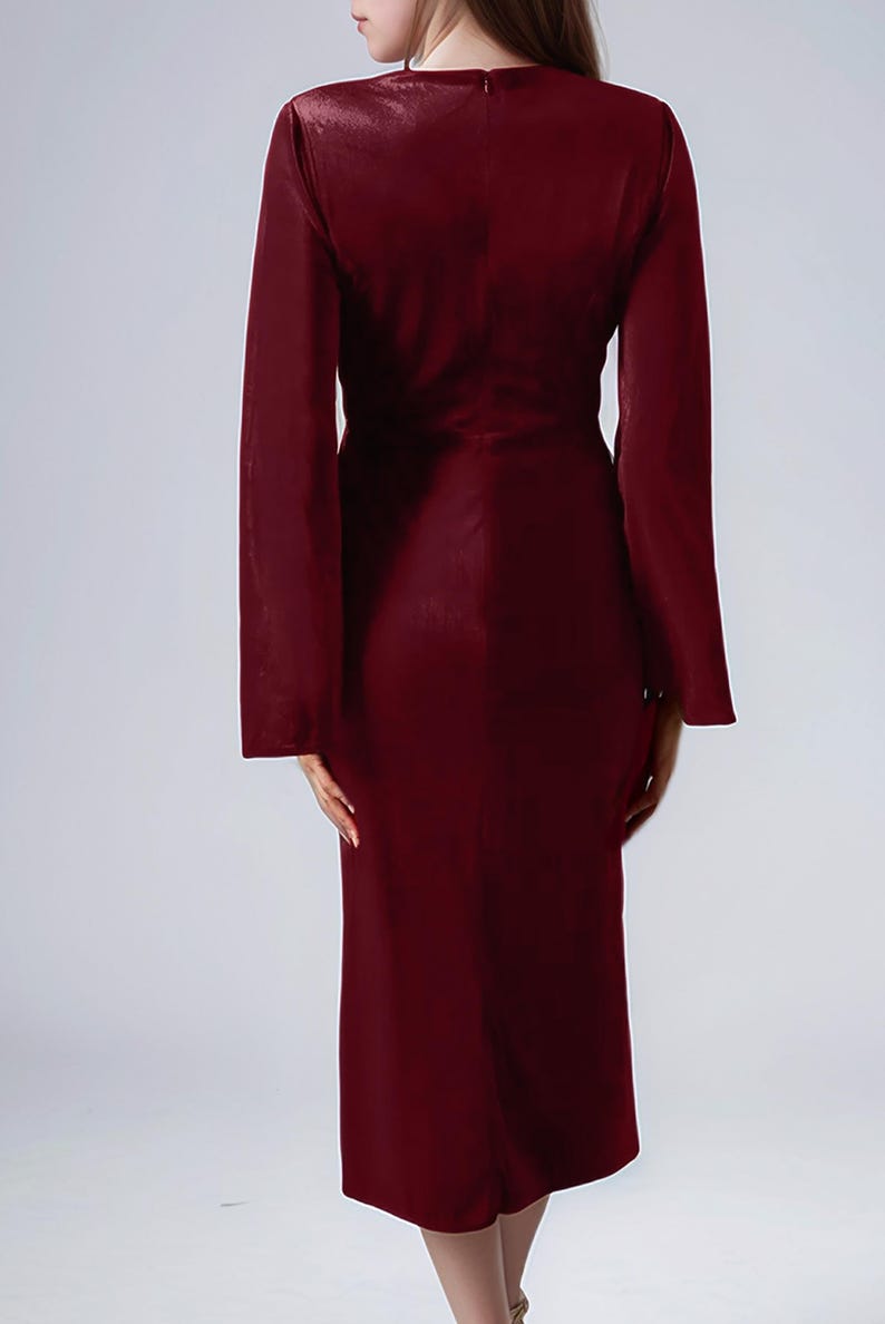 a woman in a red dress is standing