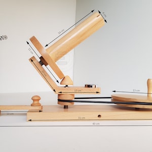 May include: Wooden yarn swift with a 16-inch spindle, a 12-inch winding wheel, and a 13-inch base. The swift measures 14 inches in length and 4 inches in diameter. The base is 31 inches long and 40 inches wide.