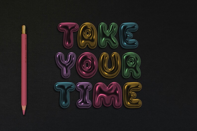 May include: The words "TAKE YOUR TIME" are spelled out in colorful, shiny, 3D letters against a black background. A pink pencil is on the left side of the image.