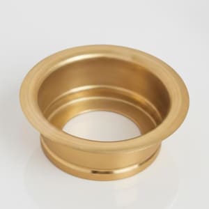 Könnte beinhalten: Ein goldfarbenes, kreisförmiges Metallobjekt mit breitem, ausgestelltem Rand und einer zentralen Öffnung. Das Objekt hat eine glatte, polierte Oberfläche, möglicherweise für Sanitäranlagen oder Möbel. Durchmesser ca. 10 cm.