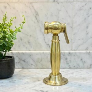 Unlacquered Solid Brass Sink side Sprayer faucet.