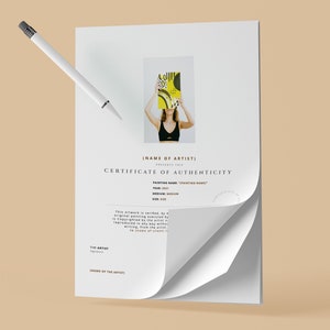 May include: A certificate of authenticity with a curled corner, featuring a woman holding a painting. The certificate includes text such as "Certificate of Authenticity" and "Painting Name". A white pen hovers above the document.