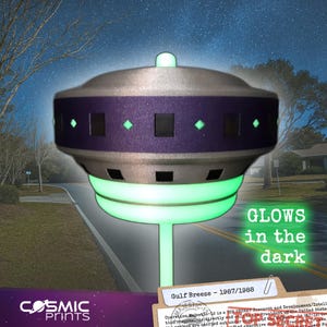 May include: A glowing, silver and purple UFO-shaped object with green accents and the text "GLOWS in the dark." The object has a series of square and diamond-shaped cutouts. The text "COSMIC PRINTS" is at the bottom.