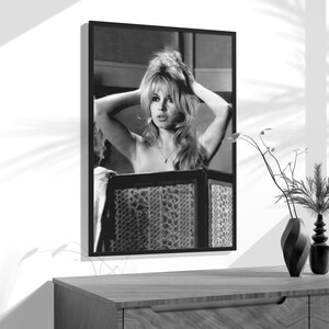 a black and white photo of a woman in a bra