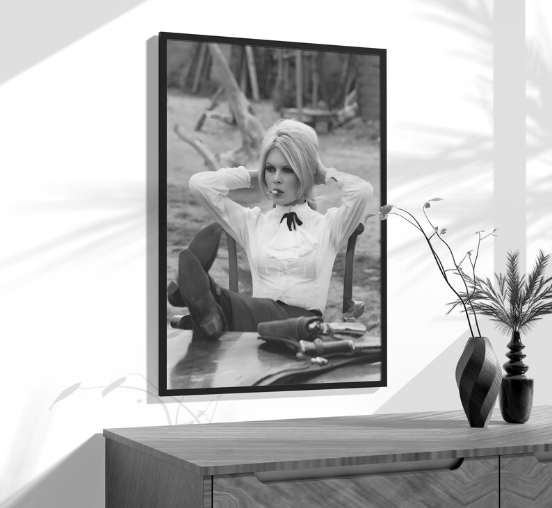 a black and white photo of a woman sitting in a chair