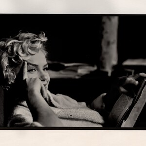 a black and white photo of a woman in a bathrobe