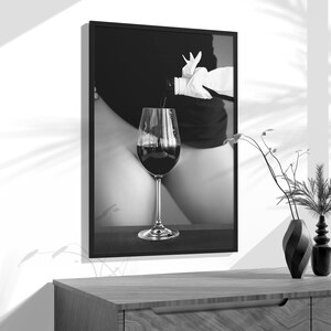 a black and white photo of a glass of wine