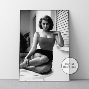 a black and white photo of a woman in fishnet stockings