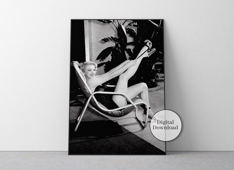 May include: A black and white photographic print featuring a smiling person with light hair sitting in a lounge chair, adjusting a high-heeled shoe on one foot. The image includes a circular overlay with the text Digital Download in the corner.