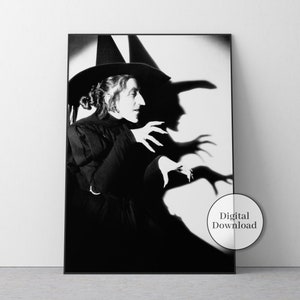 May include: Black and white framed print featuring a portrait of a witch in a tall hat, with long fingernails, and a dramatic shadow. The image has a vintage aesthetic and includes a "Digital Download" sticker.