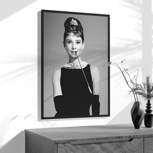 a black and white photo of a woman in a black dress