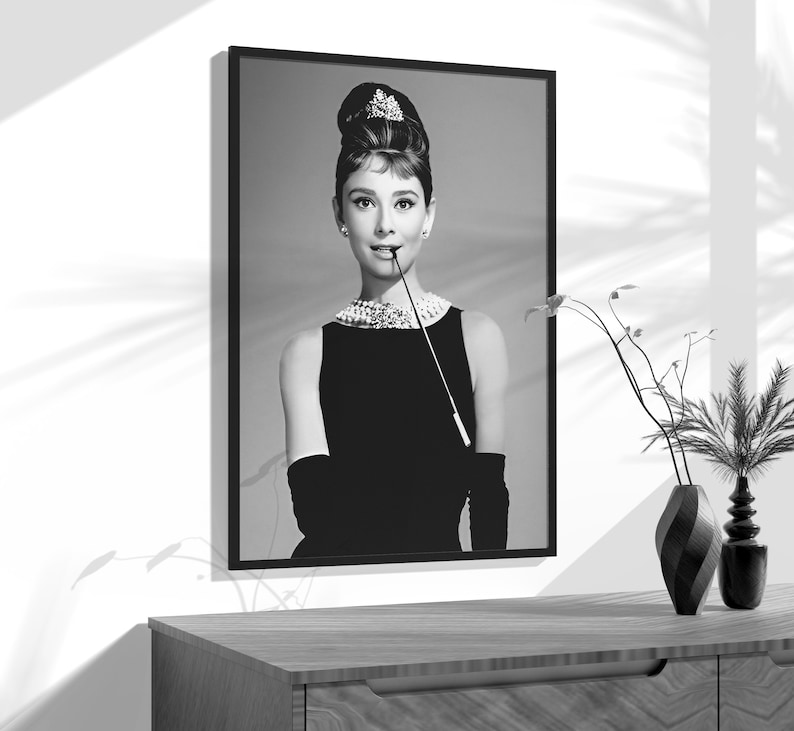 a black and white photo of a woman in a black dress