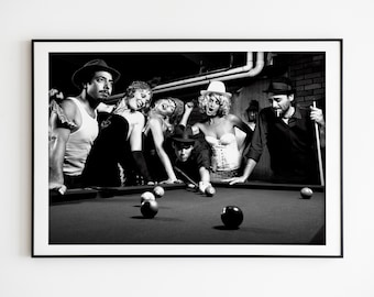 May include: Monochrome framed print depicting a group of people around a pool table. The image shows a game in progress, with several people observing. The scene is set in a dimly lit room, creating a vintage atmosphere.