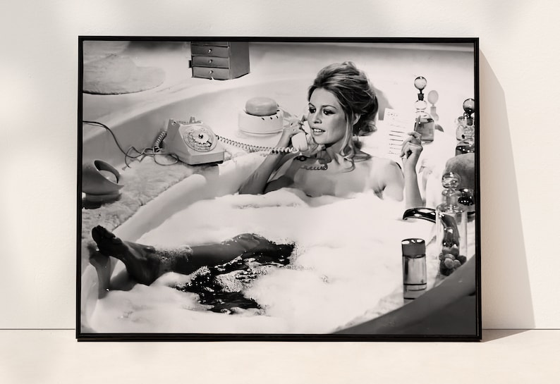 a black and white photo of a woman in a bubble bath