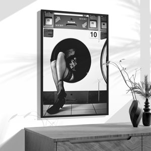 a black and white photo of a woman's legs in a washing machine