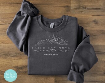 May include: A dark gray sweatshirt with a white graphic design that says "Faith can move mountains" and "Matthew 17:20".