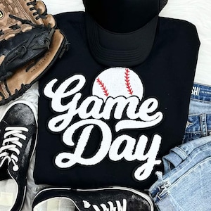 May include: Black sweatshirt with a white and red embroidered baseball and the text "Game Day".