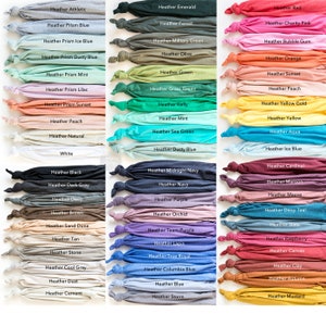May include: A collection of folded t-shirts in various colors, each labeled with its corresponding heather shade. Colors range from neutral tones like white and gray to vibrant hues such as red, blue, and green. The image showcases a wide array of options for apparel.