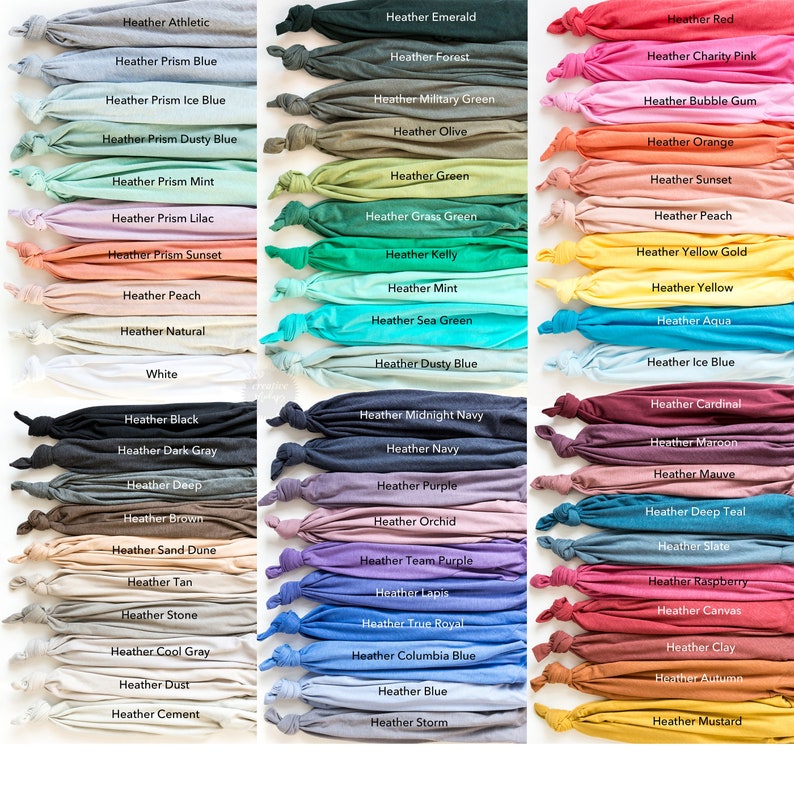 May include: A collection of folded t-shirts in various colors, each labeled with its corresponding heather shade. Colors range from neutral tones like white and gray to vibrant hues such as red, blue, and green. The image showcases a wide array of options for apparel.