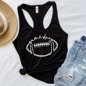 May include: Black tank top with a white graphic of a football and the text "game day".