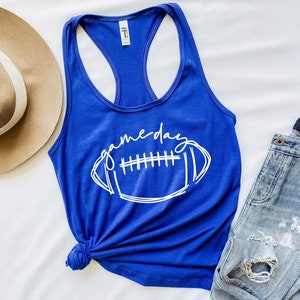 May include: A royal blue tank top with a white graphic of a football and the text "gameday".
